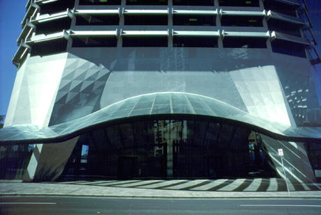 The gathered columns and entrance glass canopy